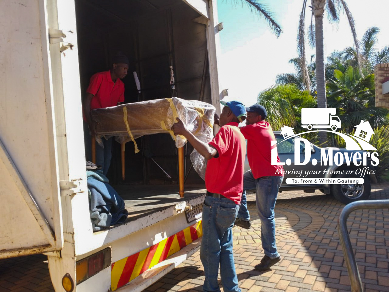 L.D. Movers crew loading furniture into the moving truck